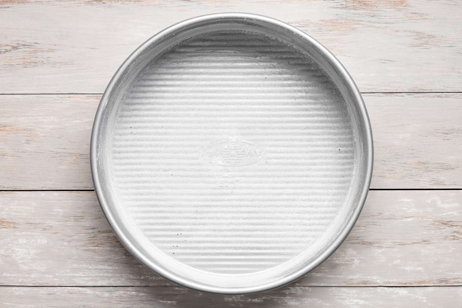 Greased Cake Pan for Chocolate Chip Cookie Cake