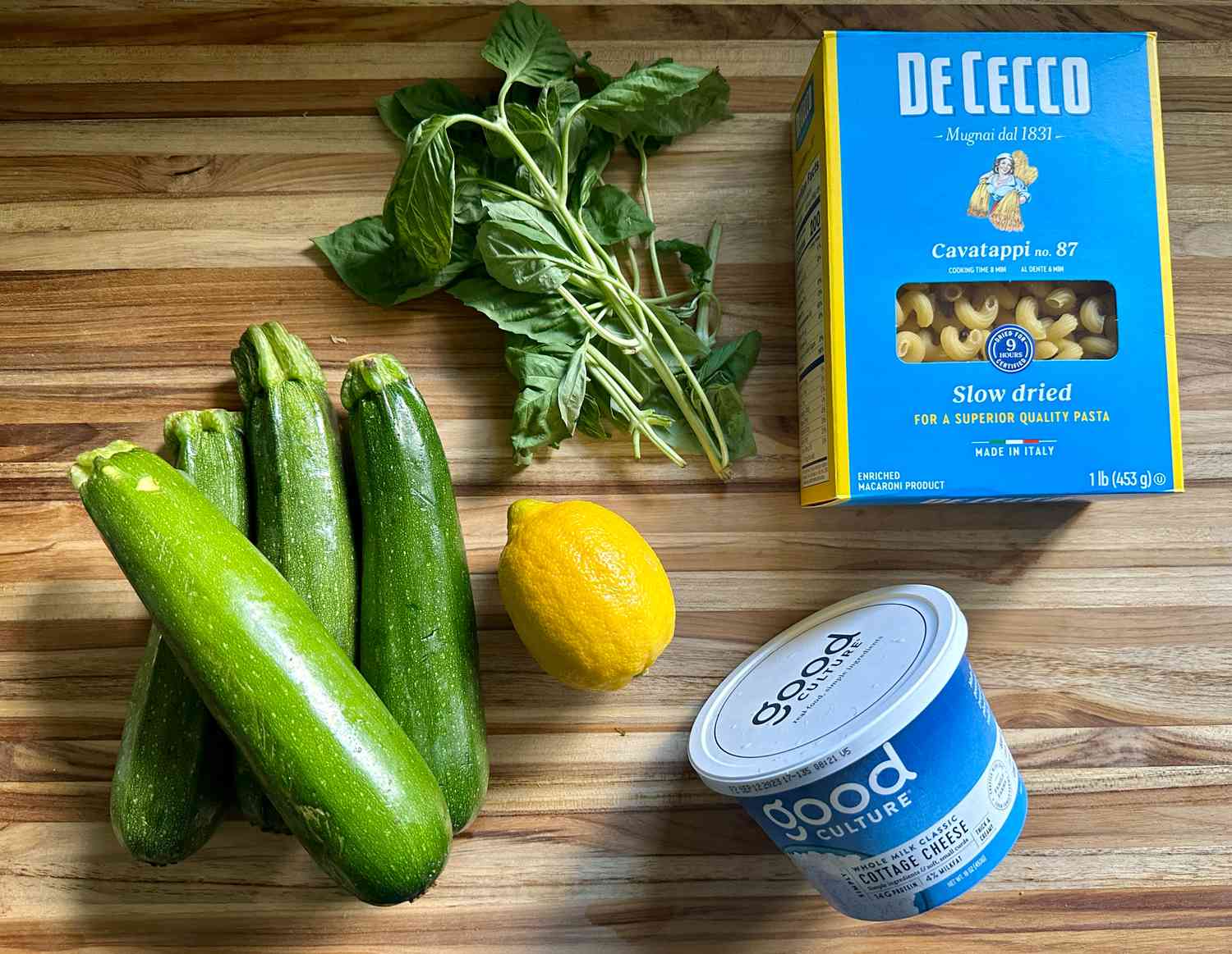ingredients for 5-ingredient zucchini pasta on a wooden surface