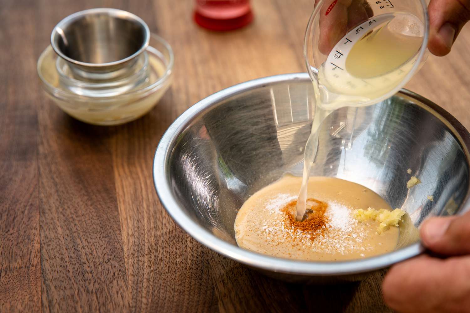 Lemon Juice Added to Bowl of Sauce Ingredients for Okra Recipe