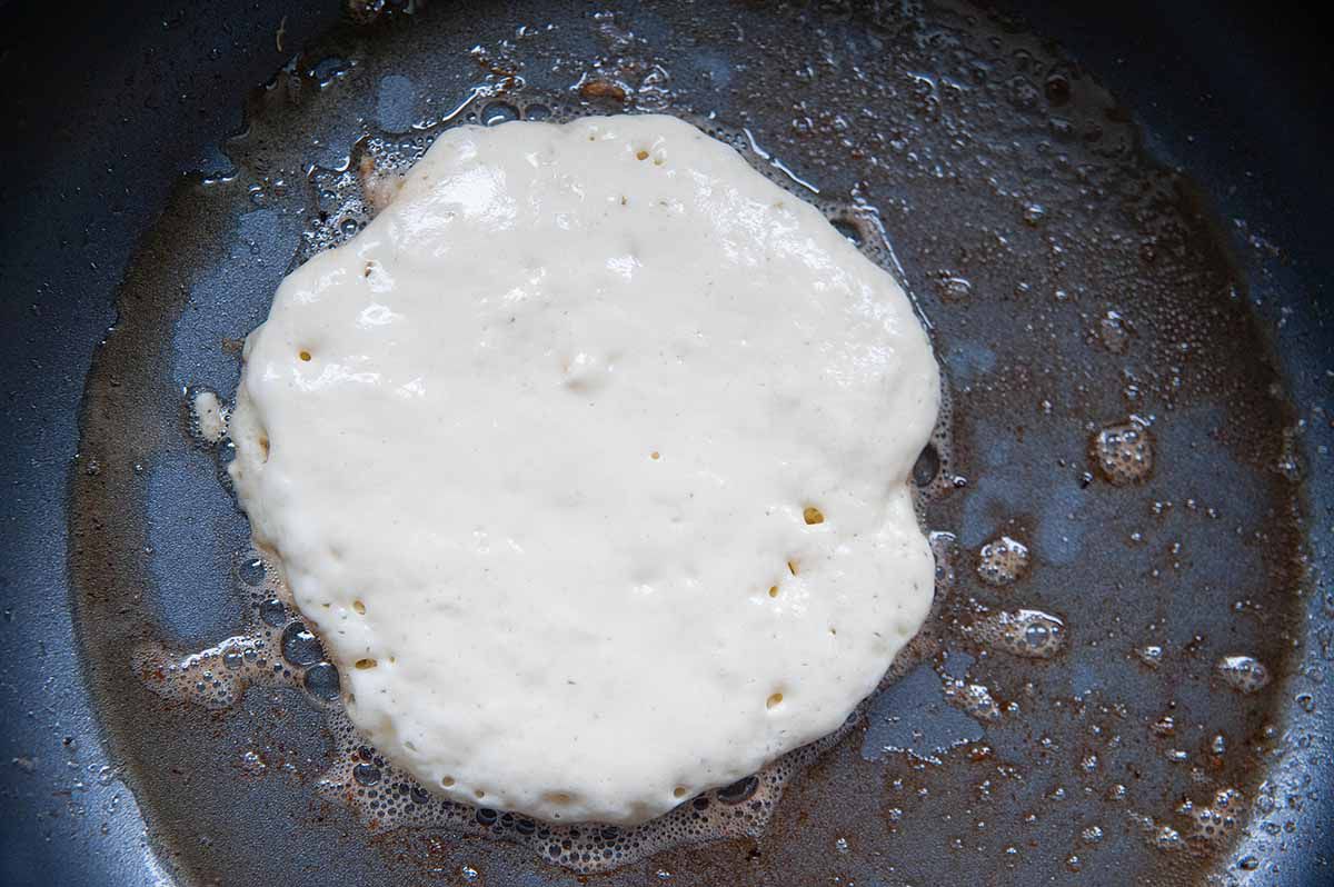 Cooking pancake batter in a greased nonstick skillet