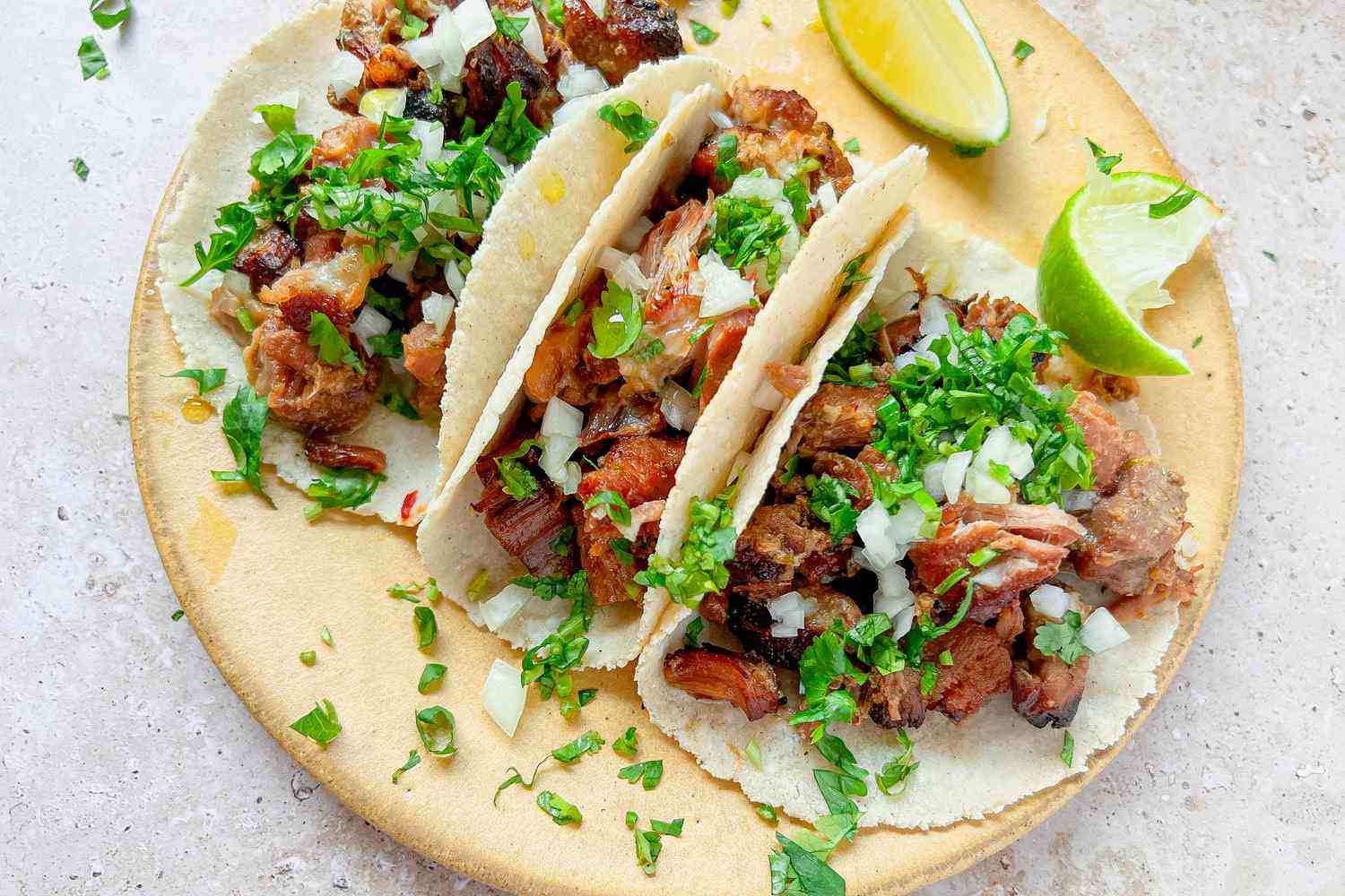 Carnitas Tacos Topped with Chopped Cilantro, Onions, and Lime