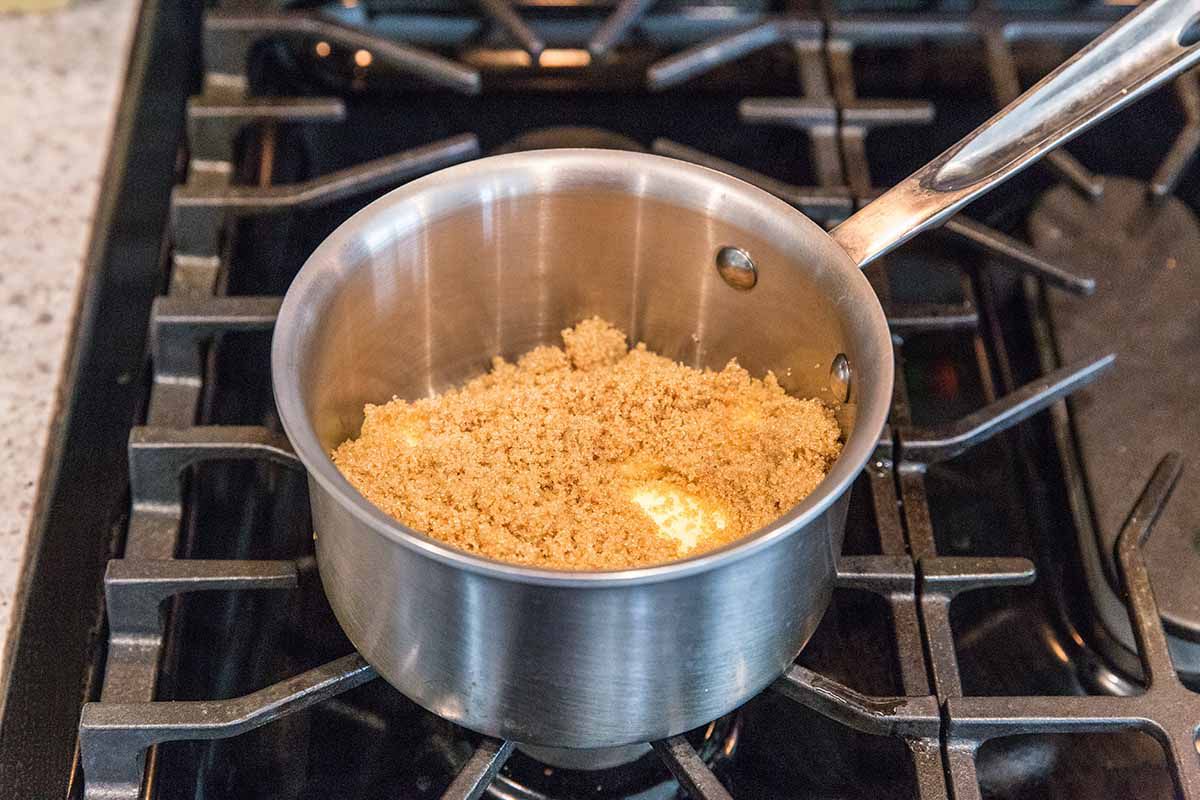 Matzo Toffee Bar Crunch - brown sugar in a silver pot on a gas stove