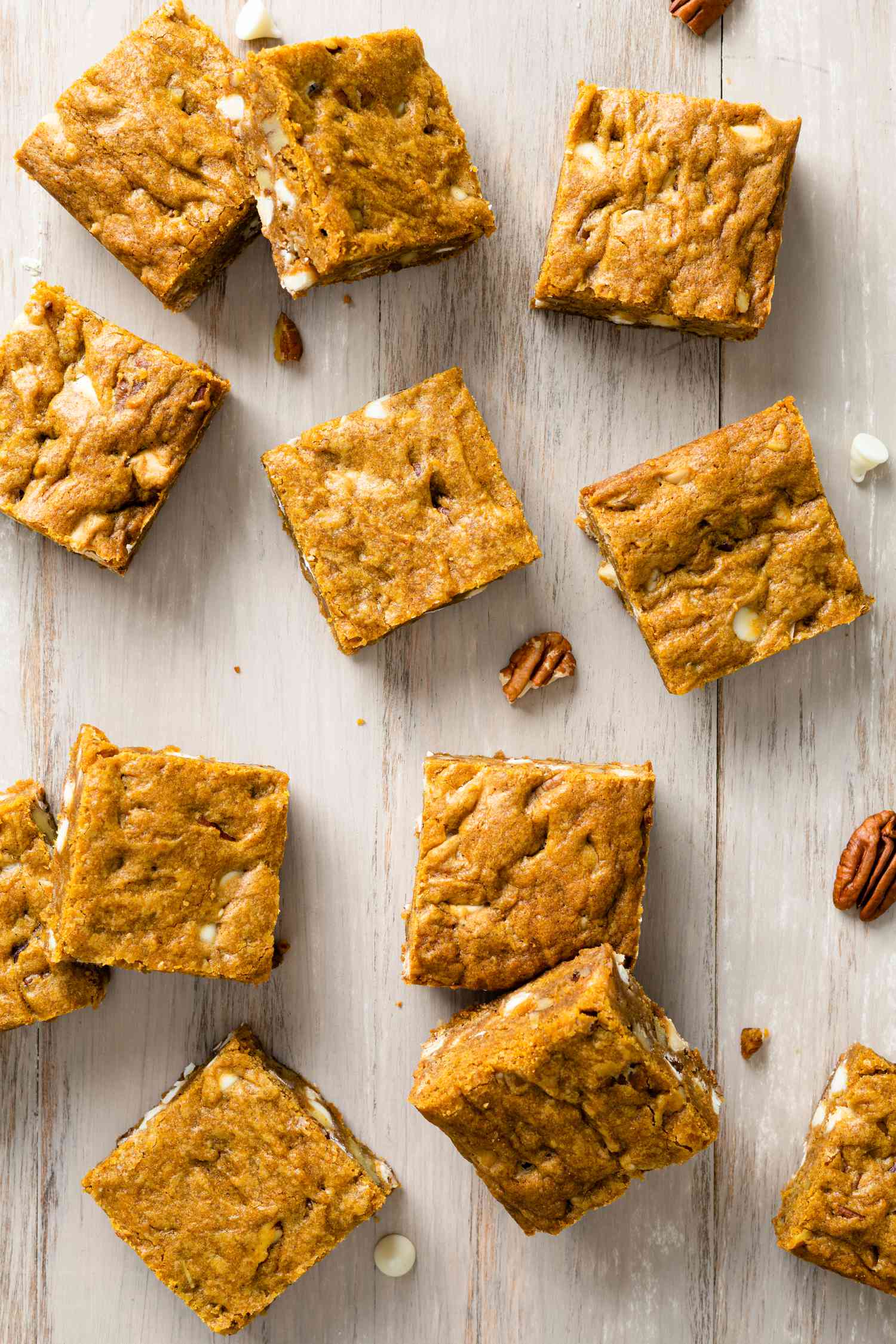 Pumpkin Blondies Bars on a Counter with Pecans and White Chocolate Chips