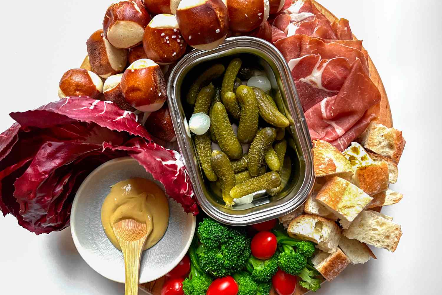 Overhead view of a tray of various foods to dip in cheese fondue