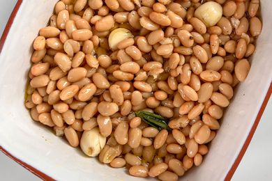 white beans with garlic and rosemary in a white casserole