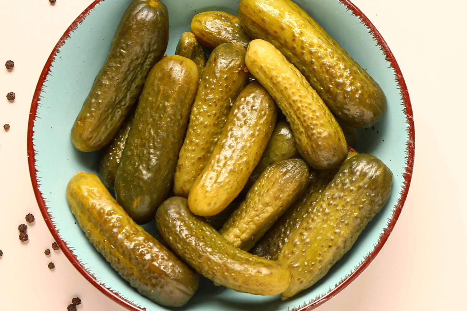 A blue bowl filled with pickles