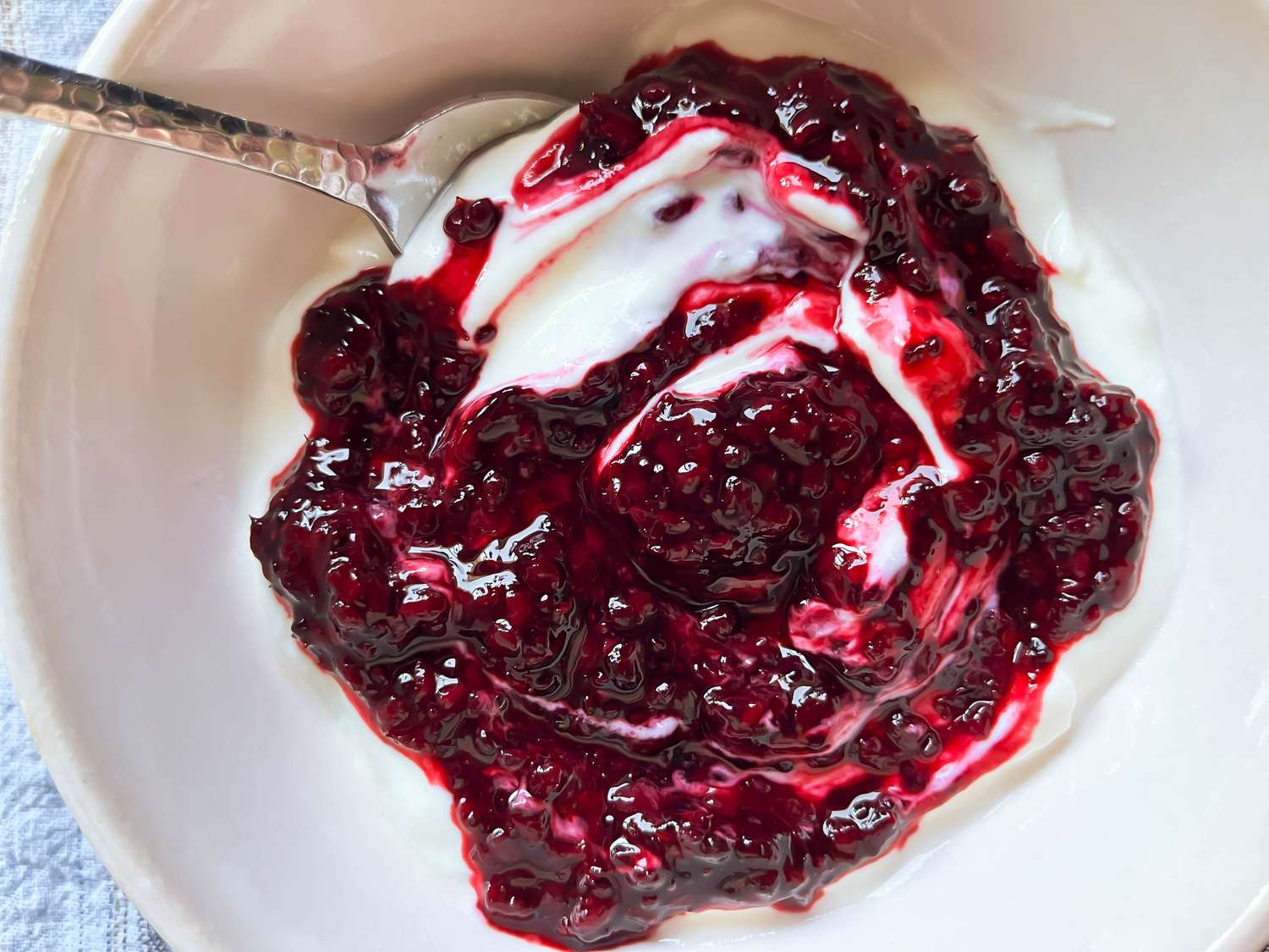 A bowl of yogurt with marionberry chia seed jam stirred in