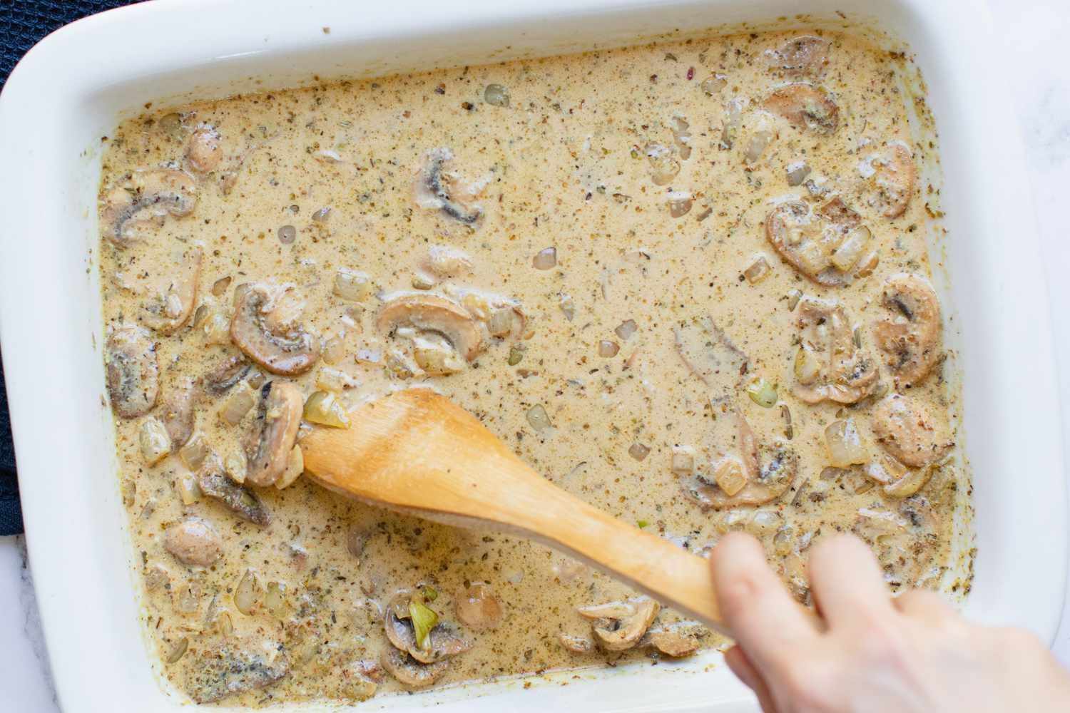 Mixing ingredients for chicken and rice casserole