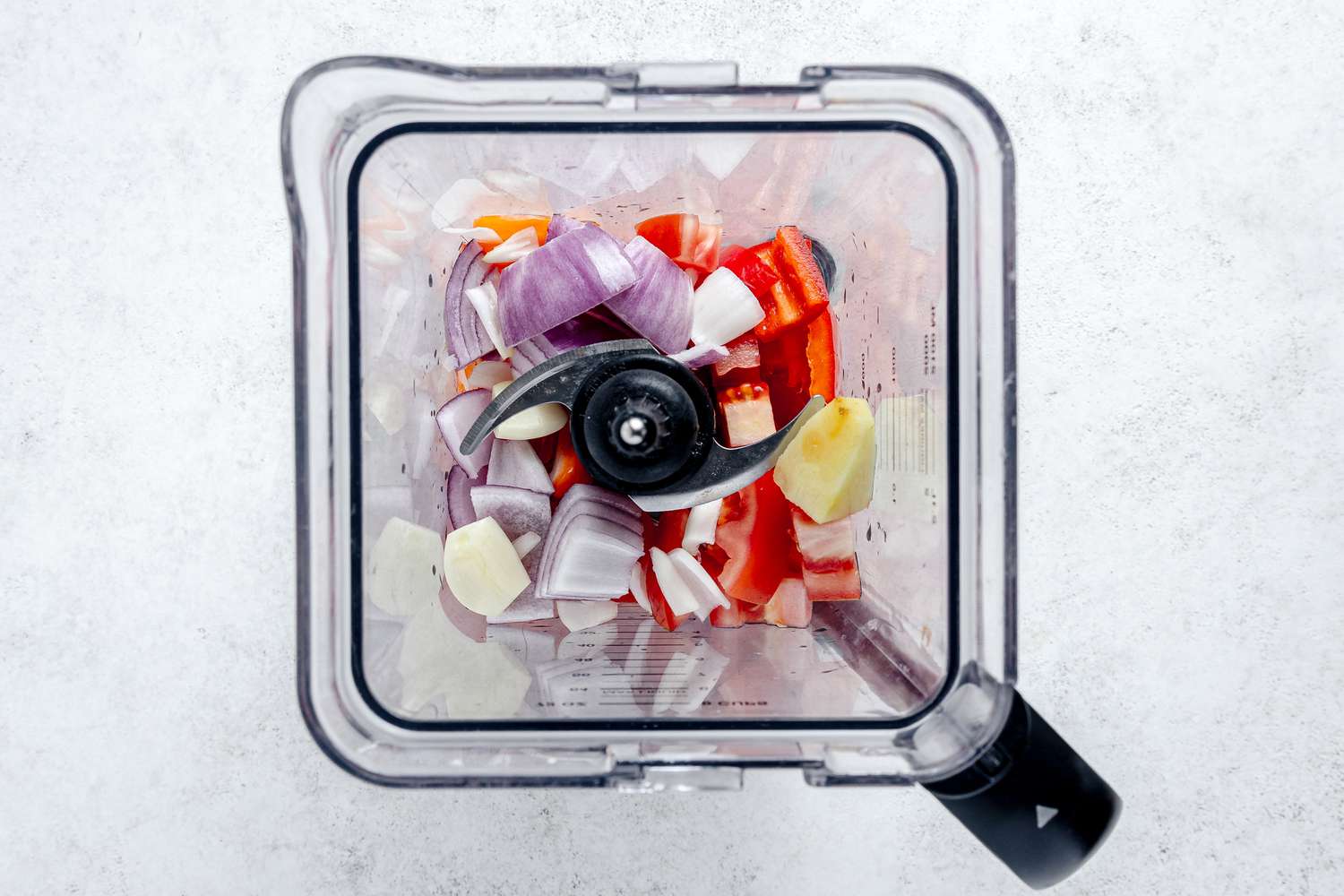 Onions, Peppers, Garlic, and Ginger in a Blender for West African Jollof Rice Recipe