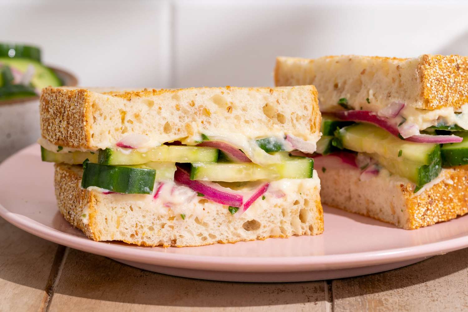 Sandwiches with cucumber and red onions served on a plate