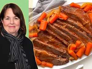 Ina Garten alongside a platter of sliced brisket with carrots and onions