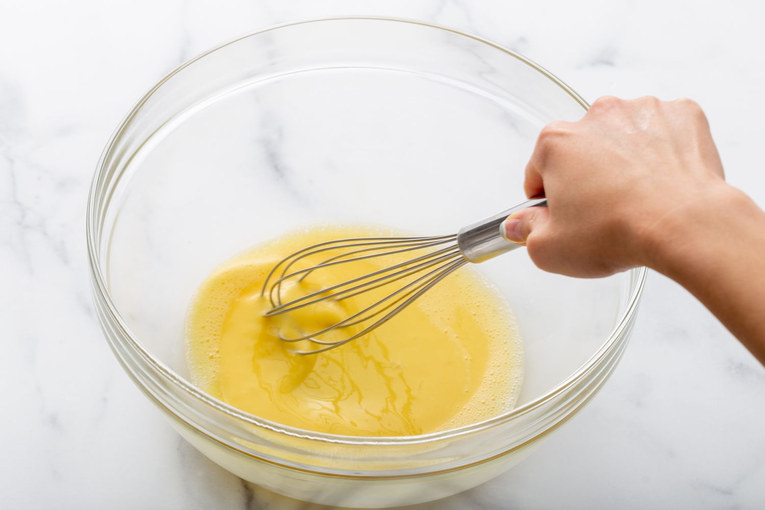Whisking eggs in a glass bowl