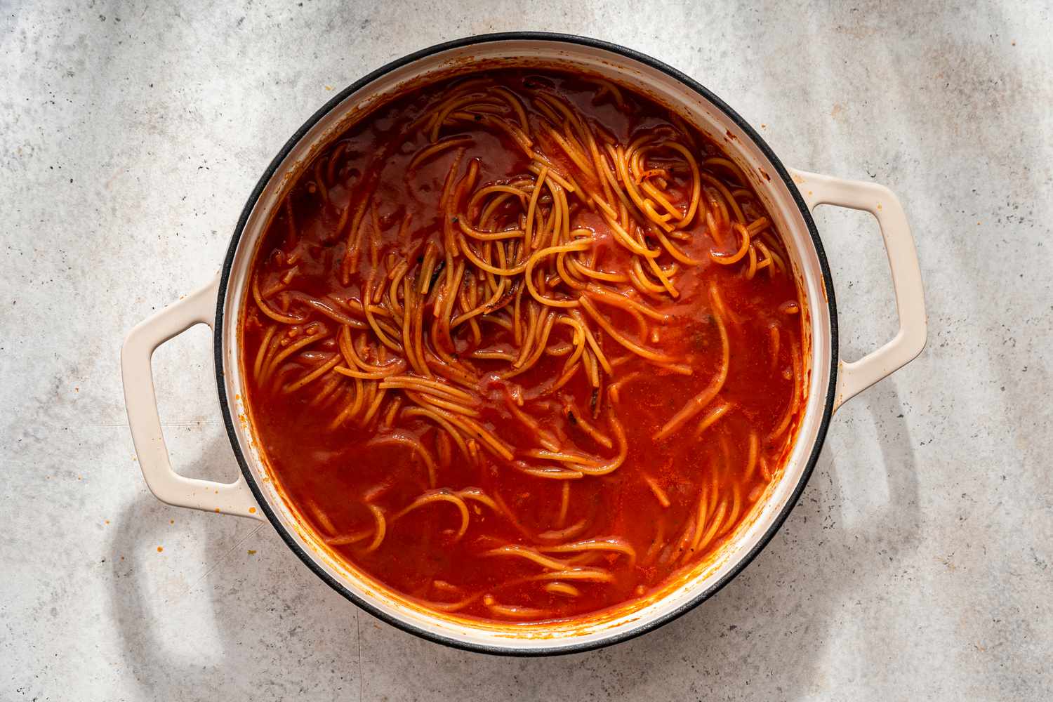 Cook down tomato sauce with the pasta for assassin's spaghetti recipe 