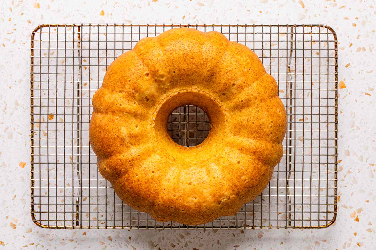 ciambellone (out of the bundt pan) resting on a cooling rack 