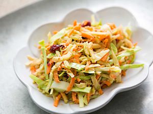 Broccoli Slaw with Cranberry Orange Dressing in a white bowl
