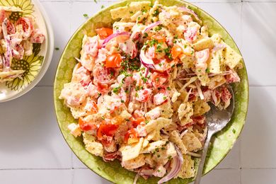 Tomato cracker salad in a bowl with a serving spoon