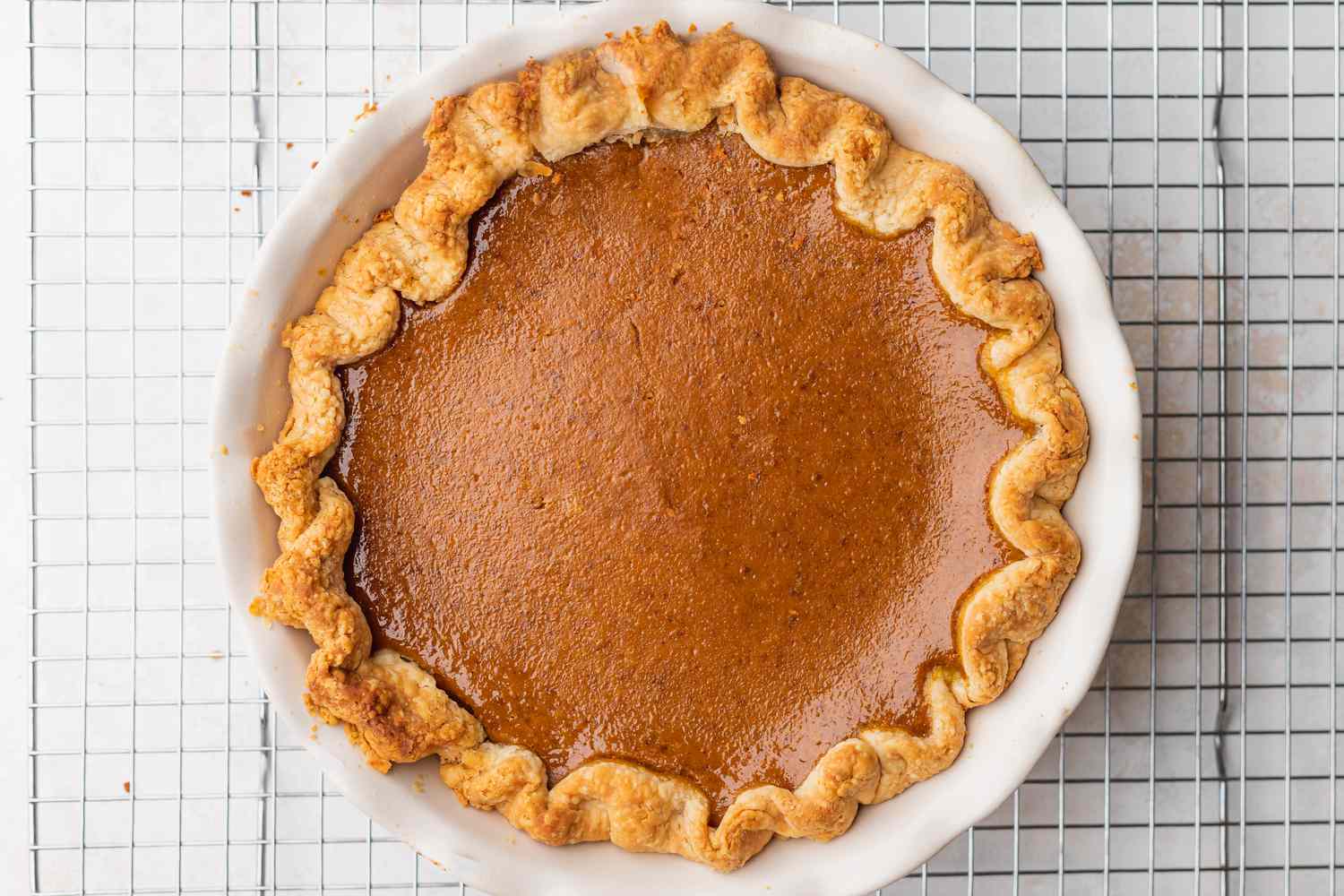 Old Fashioned Pumpkin Pie Resting on a Cooling Rack