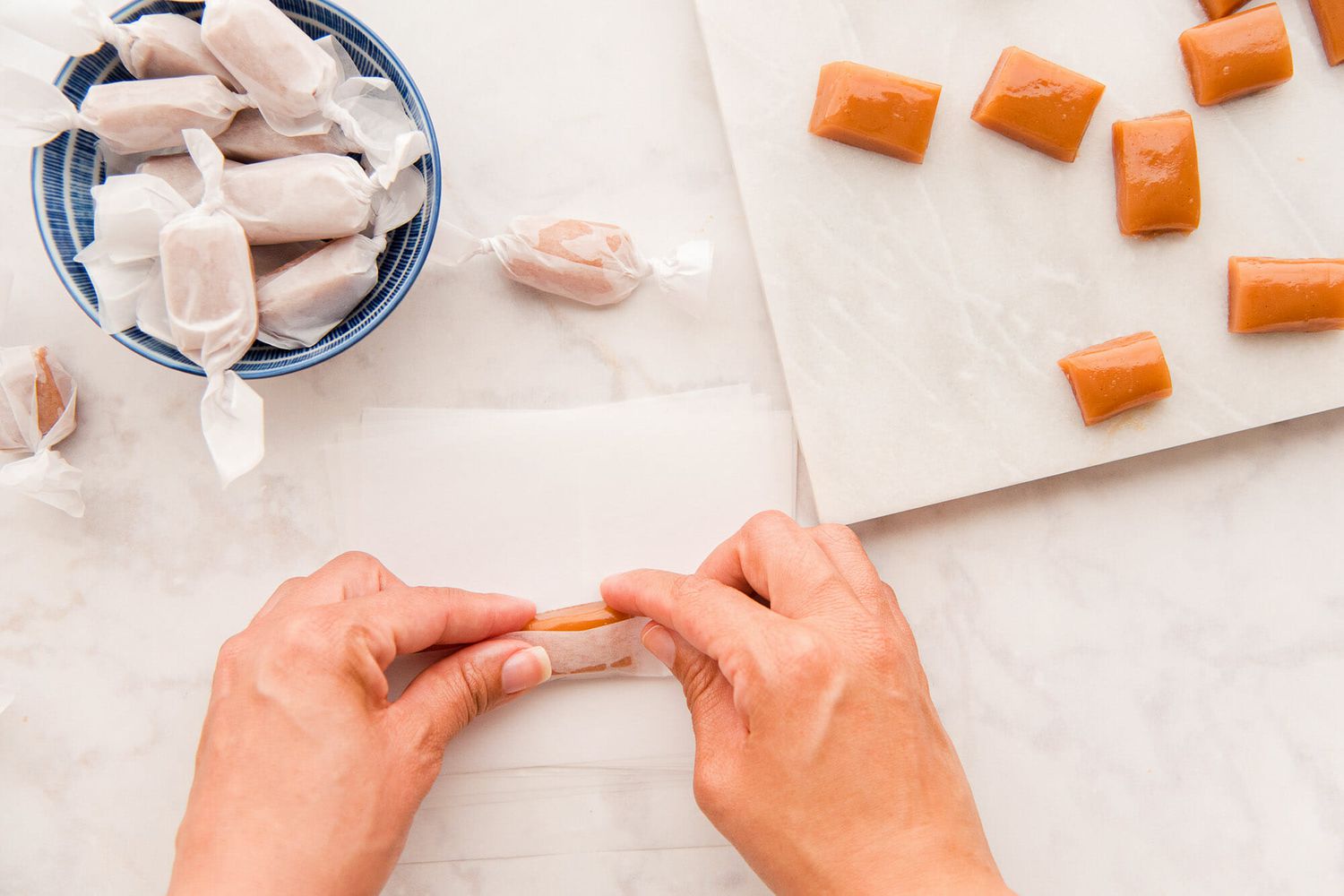 Wrapping Classic Caramel Candies in wax paper for Homemade Caramel Candy.