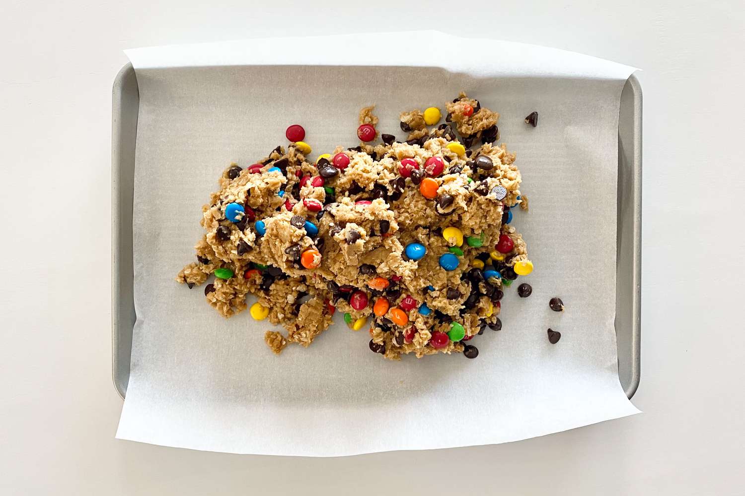 Dough for The BEST GF Monster Cookie Recipe in a baking pan.