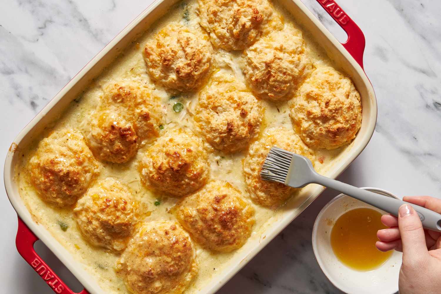 Old bay butter mixture brushed onto the cheddar bay biscuit top for chicken cobbler recipe