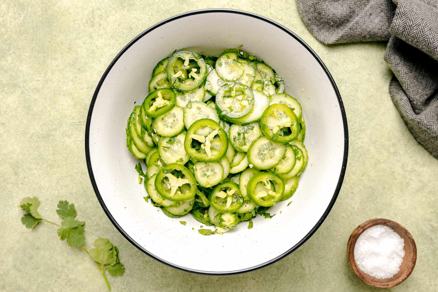 Spicy Cucumber and Jalapeño Salad with a Small Bowl of Salt Next to It 