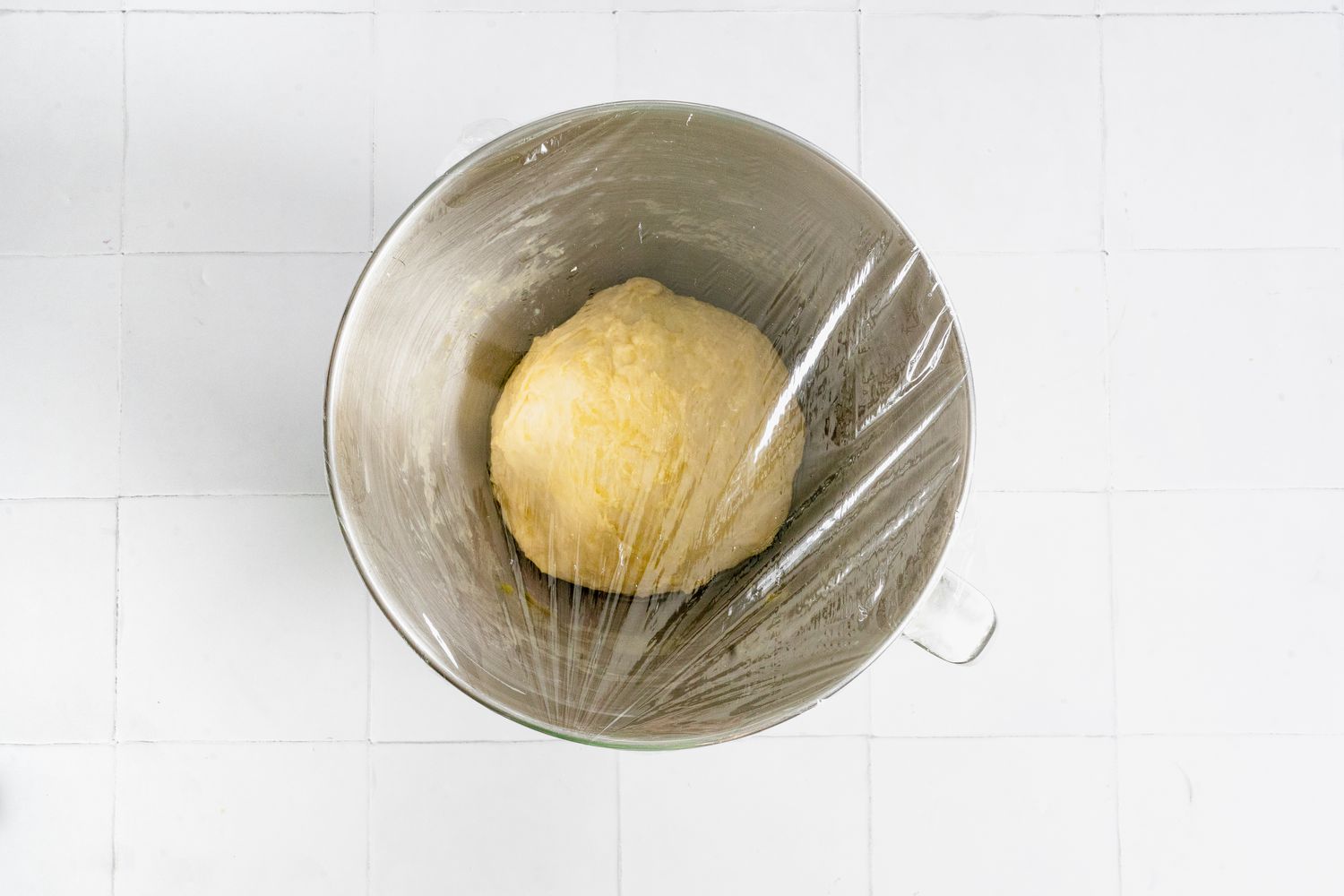 Dough Resting in Mixer Bowl Covered with Plastic Wrap for Mini Challah Rolls Recipe
