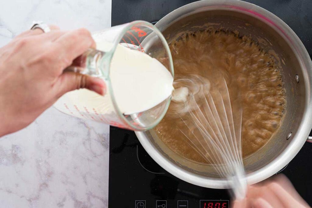 Easy Banoffee Cheesecake - pouring cream to make toffee sauce