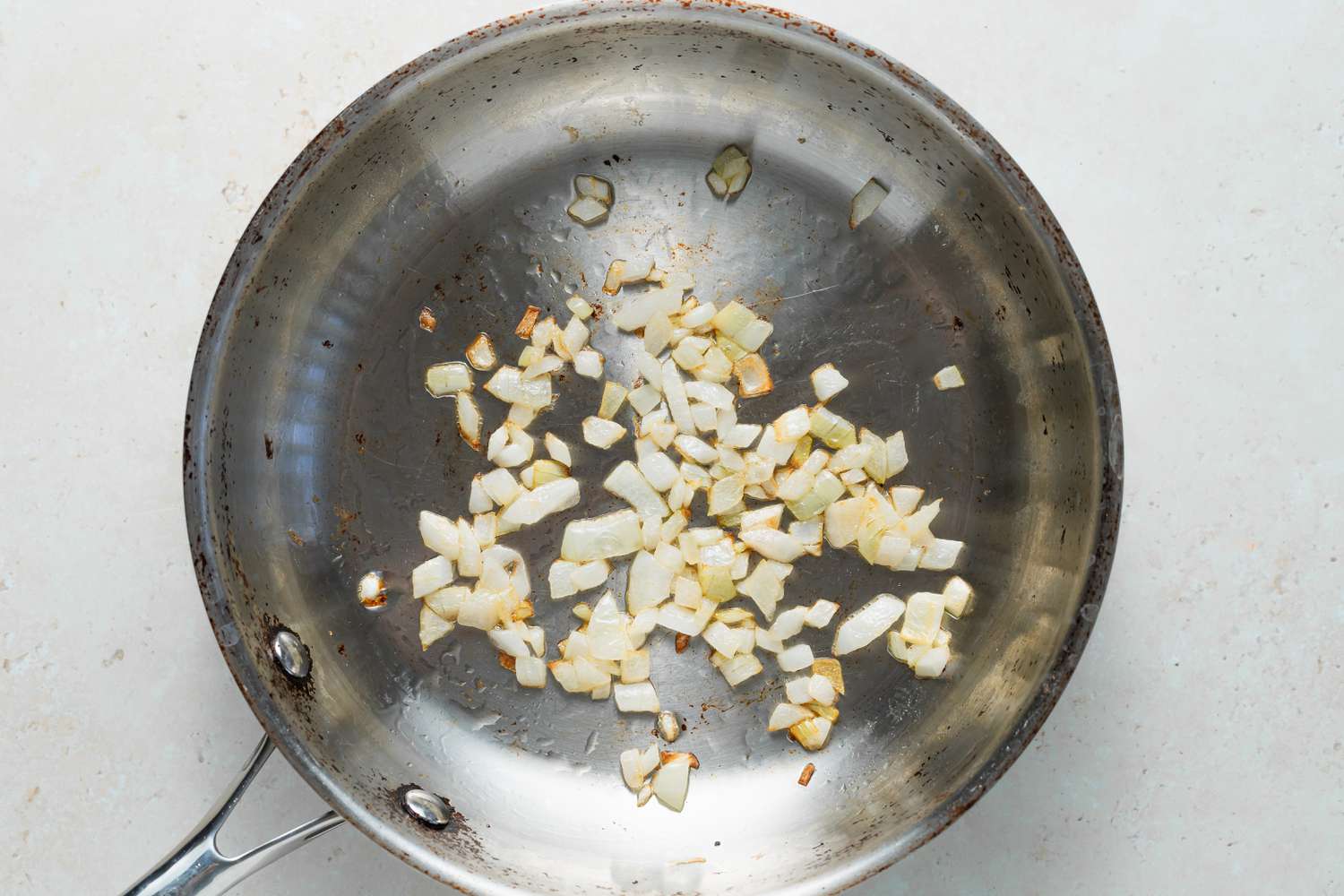 Sauteeing onions in a skillet to make chile relleno casserole.