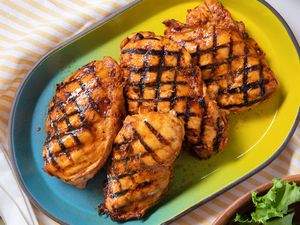 grilled chicken on a platter at a table setting