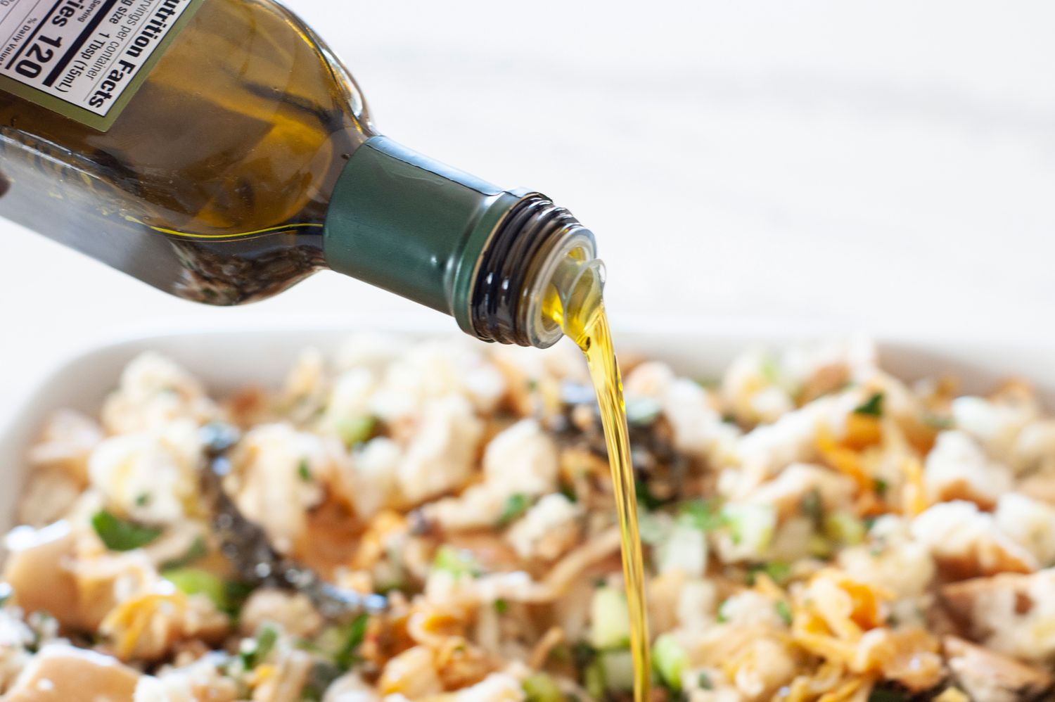 Drizzling olive oil over stuffing.