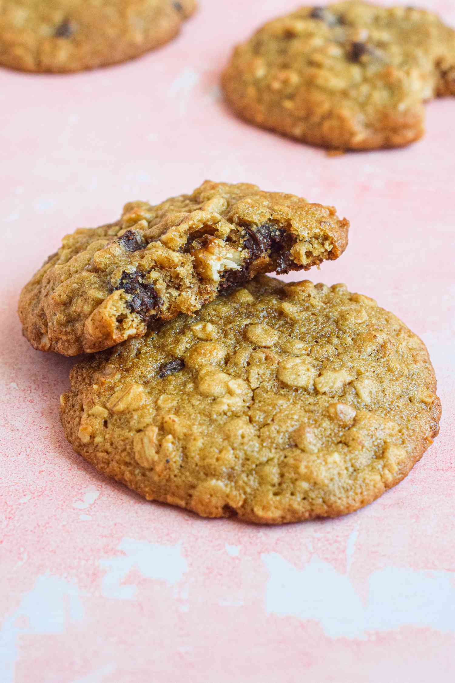 Oatmeal Banana Cookies on the Counter with a Bitten Cooking Leaning on an Unbitten Cookie 