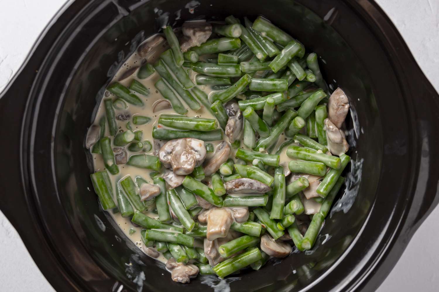 Green Bean Casserole Ingredients Added to Slow Cooker 