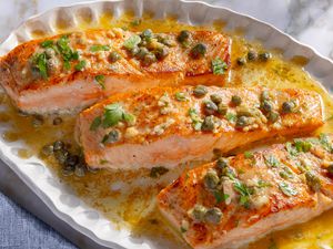 overhead view of platter of Salmon Piccata fillets