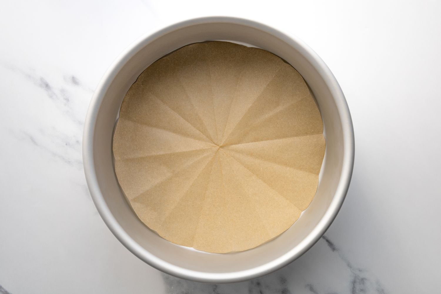 A round cake pan lined with parchment paper