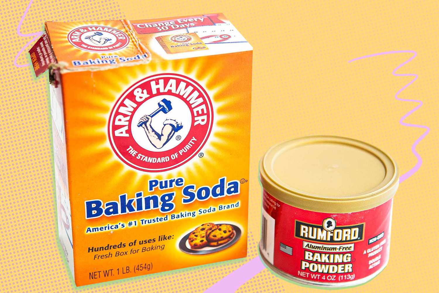 A box of baking soda next to a small tin of baking powder