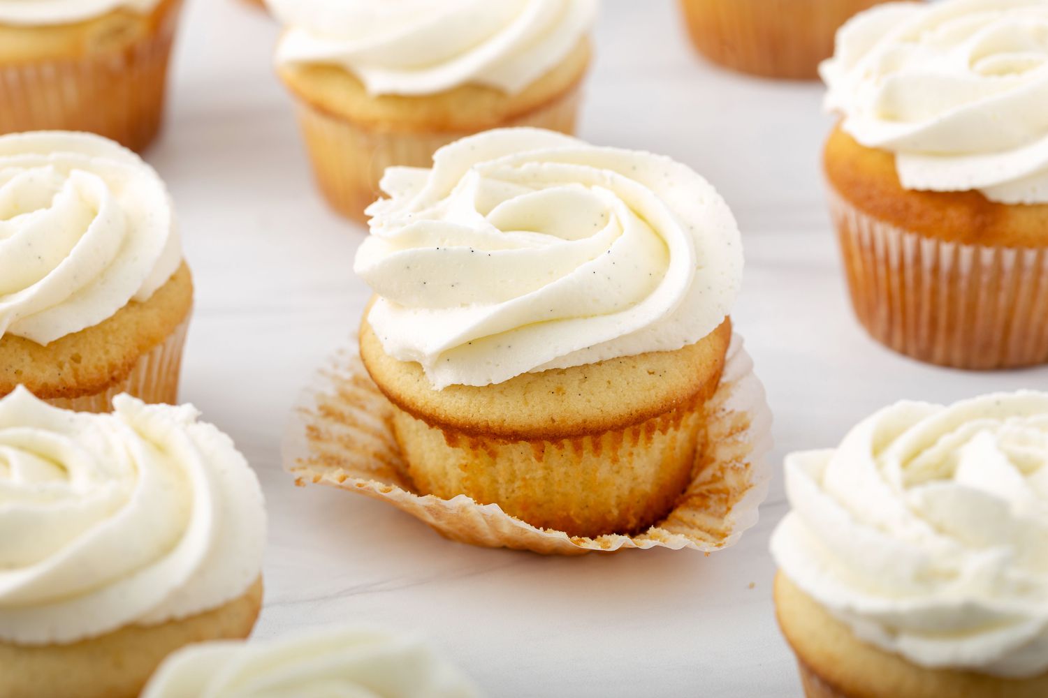 Close up of vanilla cupcakes with swirls of vanilla icing