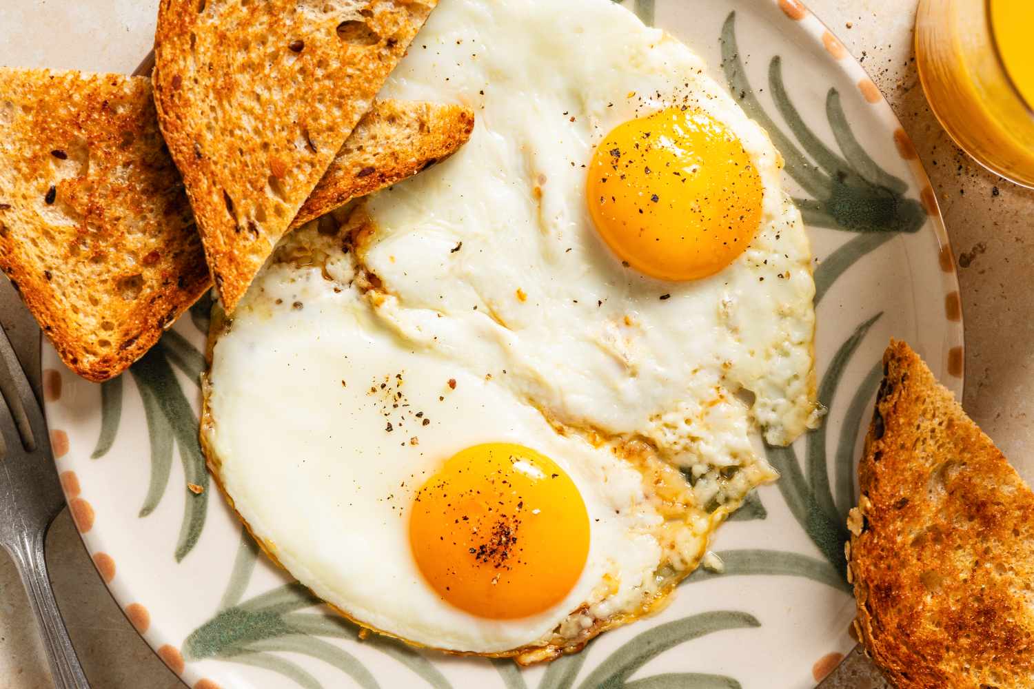 Fried eggs with toast on a decorative plate