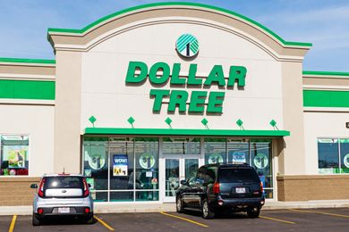 The exterior of a Dollar Tree storefront with parked cars in front