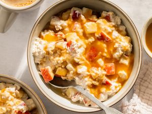 A bowl of overnight oats topped with diced apple and caramel drizzle