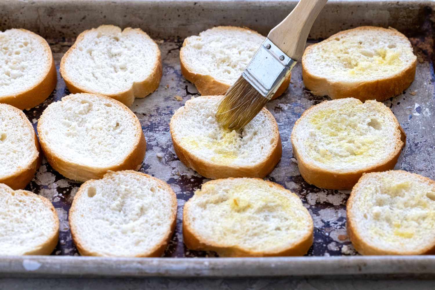 Baking the toasts for mushroom, onion, and goat cheese crostini.