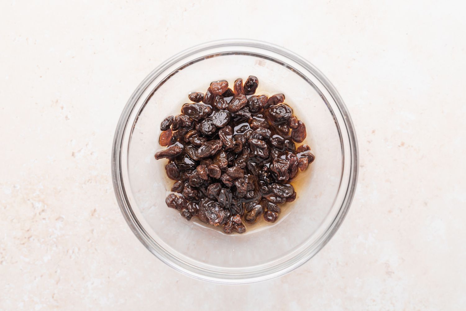Soaking raisins for the best bread pudding recipe.