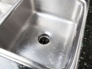Stainless steel sink with a garbage disposal