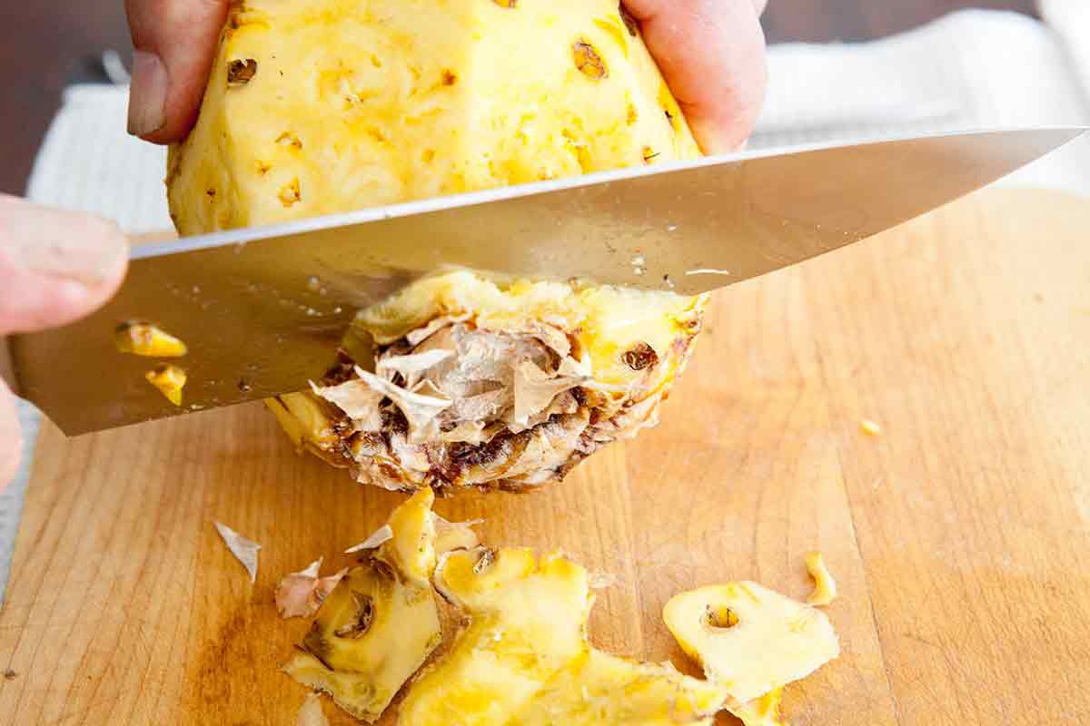 slice off the bottom of the pineapple