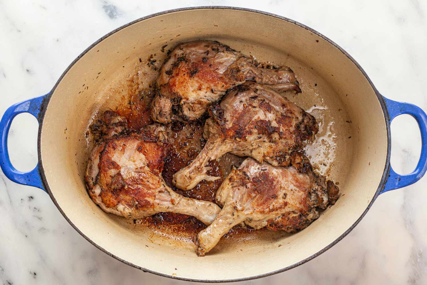 Four whole duck confit legs in dutch oven.