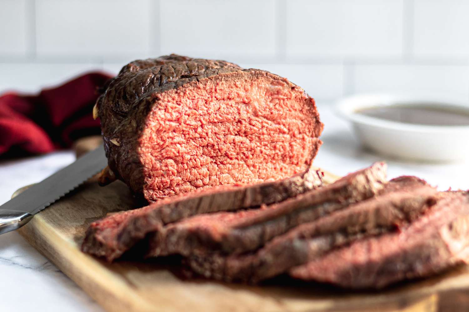 A sliced roast beef cooked to medium rare beef temperature.