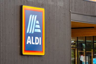 An ALDI sign on a wooden wall