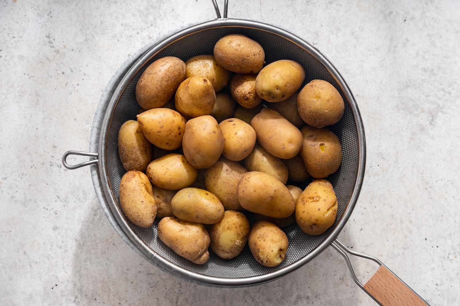 Potatoes in a sieve for crash hot potatoes recipe