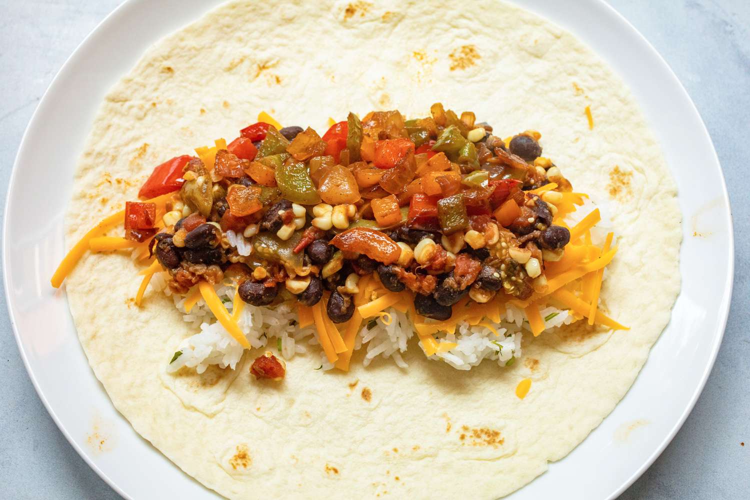 Assembling freezer-friendly vegetarian burrito.