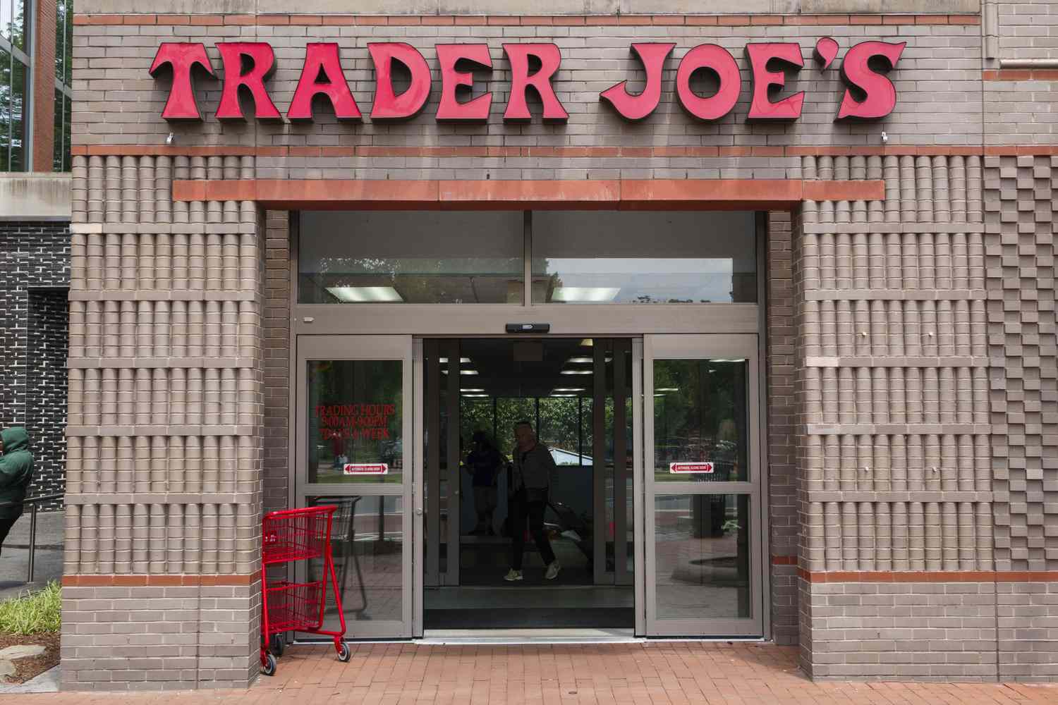 Entrance to a Trader Joes store with shopping carts nearby