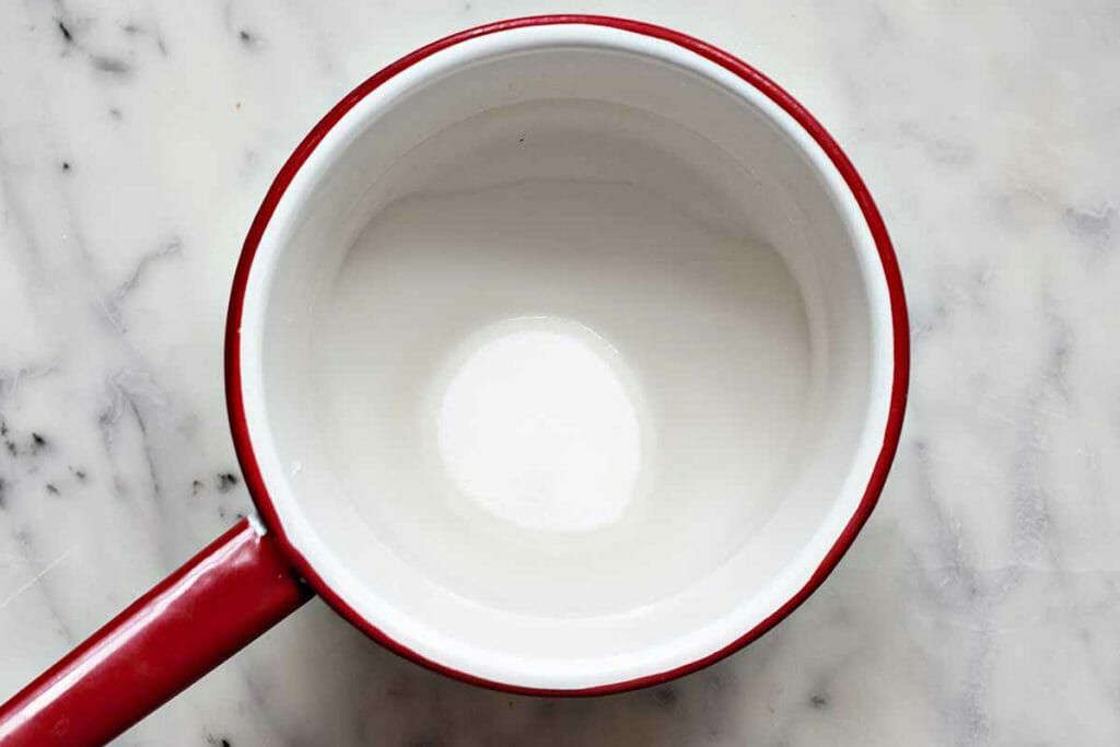 Simmer sugar and water in a pan to make simple syrup